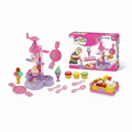 A children's play set labeled 'Wheat Mud - Creative Ice Cream Machine & Play Dough Set' shown with its retail box and multiple pink toy components on a white background. The set includes an ice cream machine, waffle maker, spoons, play dough containers, utensils, and a play dough tray with fruit and ice cream illustrations.