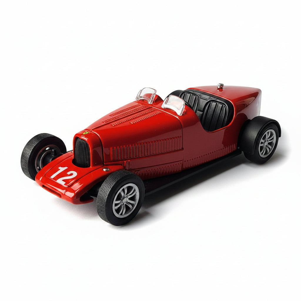 A red vintage-style race car model with black wheels, black interior, and the number 12 on the side, photographed on a light gray surface.