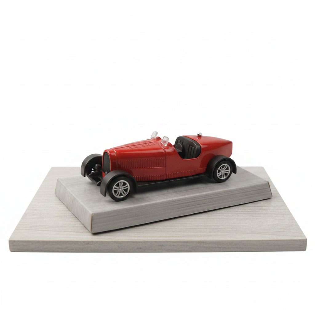 A red vintage-style toy car model displayed on a gray rectangular base against a light gray background.